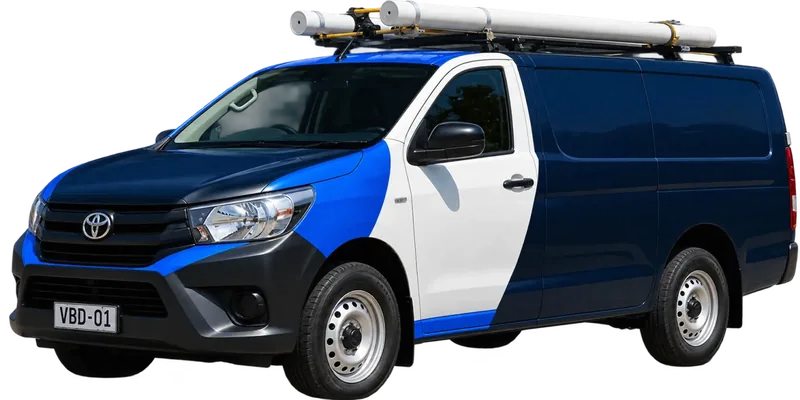 A licensed the Northern Beaches plumbing van loaded with pipe on the roof rack